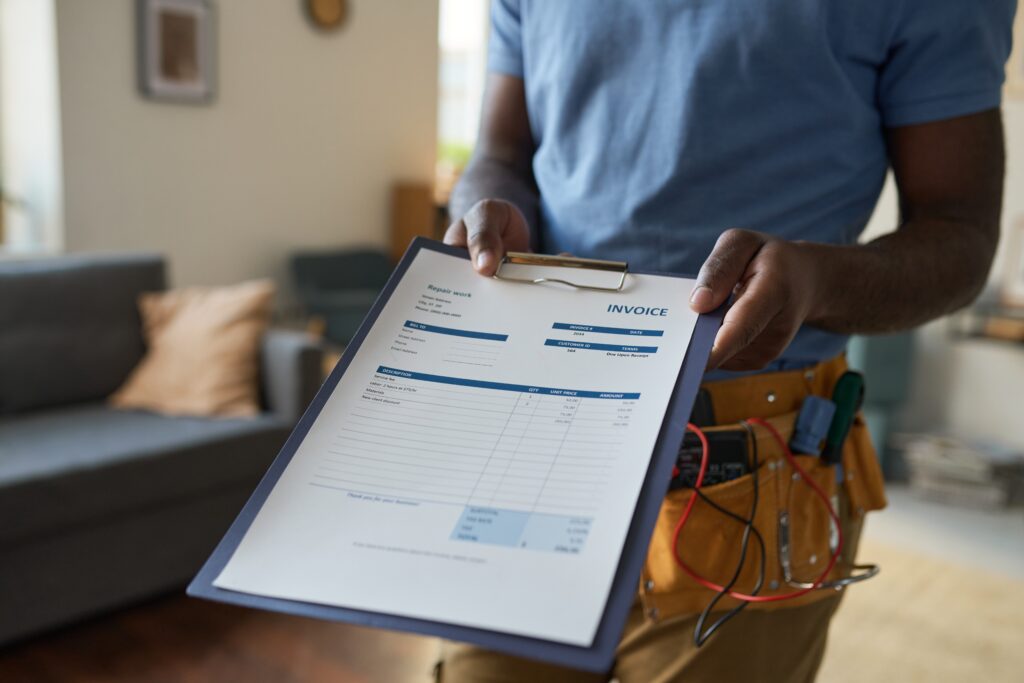 Professional performing a spring home maintenance inspection with a checklist inside a house